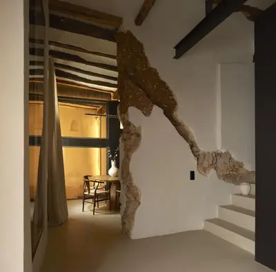 a room with stairs and a sculpture of a horse on the wall at Enoa Casa Cueva in Requena