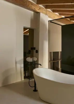 a white bath tub in a room with a table at Enoa Casa Cueva in Requena