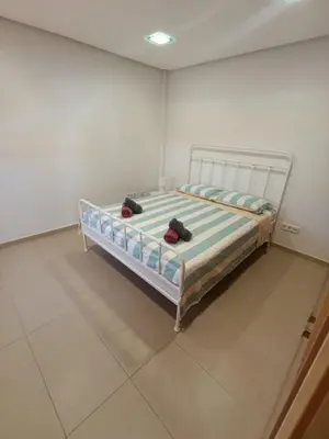 a bed in a room with two bags on it at Triplex 4 Bed Penthouse Sea Views Casa Privee - Lux Four bed Two bath Terraces & Balconies in Puerto de Sagunto