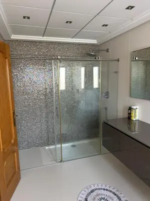 a bathroom with a shower with a glass door at Triplex 4 Bed Penthouse Sea Views Casa Privee - Lux Four bed Two bath Terraces & Balconies in Puerto de Sagunto
