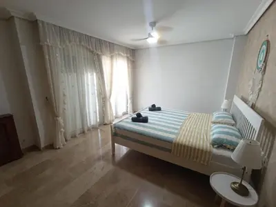 a bedroom with a bed and a window at Triplex 4 Bed Penthouse Sea Views Casa Privee - Lux Four bed Two bath Terraces & Balconies in Puerto de Sagunto