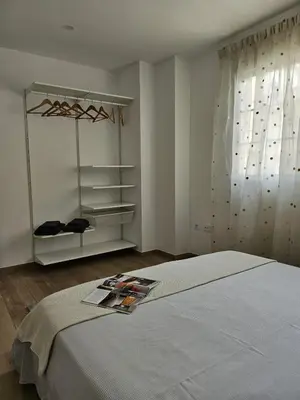 a bedroom with a bed with a magazine on it at Chic Escape Apartment in Godella