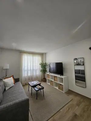 a living room with a couch and a flat screen tv at Chic Escape Apartment in Godella