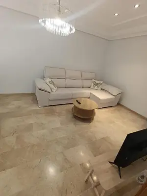 a living room with a couch and a table at First Floor Casa Privee - Two bed Beach Terrace & Balconies in Puerto de Sagunto