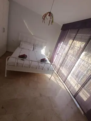 a white bed in a room with a window at First Floor Casa Privee - Two bed Beach Terrace & Balconies in Puerto de Sagunto
