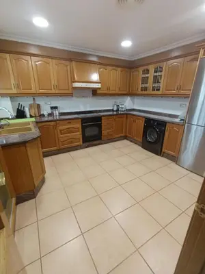 a kitchen with wooden cabinets and a dishwasher at First Floor Casa Privee - Two bed Beach Terrace & Balconies in Puerto de Sagunto