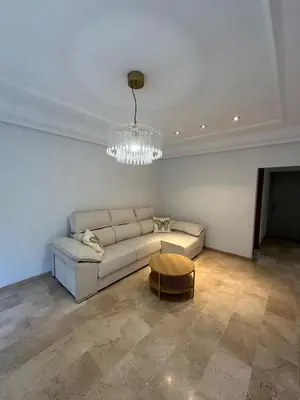 a living room with a white couch and a chandelier at First Floor Casa Privee - Two bed Beach Terrace & Balconies in Puerto de Sagunto