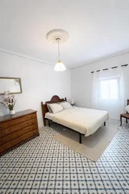 a kitchen with a brown cabinet in a room at Cullera Center, 15 min Beach in Cullera