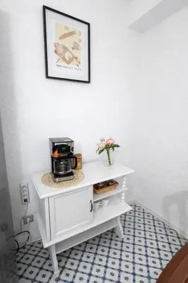 a bedroom with a bed and a clock on the wall at Cullera Center, 15 min Beach in Cullera