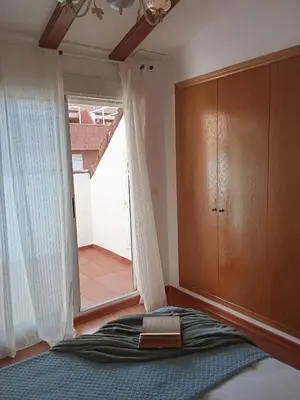 a bedroom with a bed and a large window at Valencia Casa Rosa in Sedaví