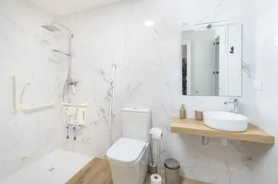 a white bathroom with a toilet and a sink at VL - Casa Girasol in Valencia