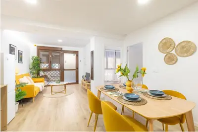 a dining room and living room with a table and chairs at VL - Casa Girasol in Valencia