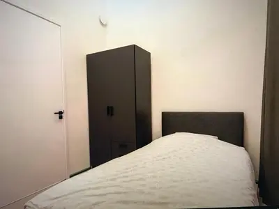a bedroom with a bed with a black cabinet at Costa de Valencia Comfort in Torrent