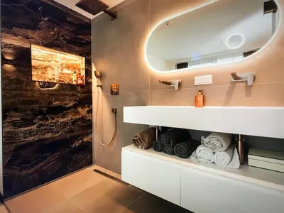 a bathroom with a sink and a mirror and towels at Costa de Valencia Comfort in Torrent