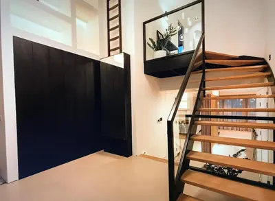 a staircase in a house with a black door at Costa de Valencia Comfort in Torrent
