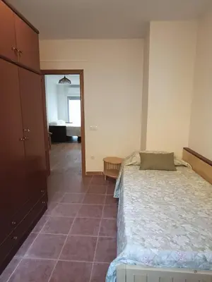 a bedroom with a bed and a tiled floor at La Senia in Moncófar