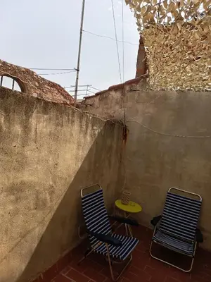 two chairs and a table next to a wall at La Senia in Moncófar
