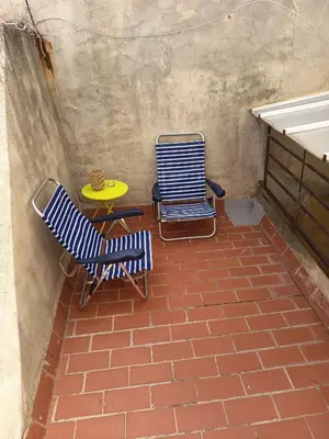 two chairs and a table with a yellow table at La Senia in Moncófar
