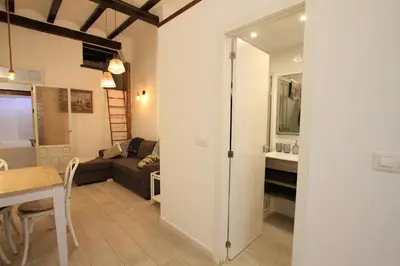 a living room with a couch and a table at Modernist house in Cabanyal in Valencia