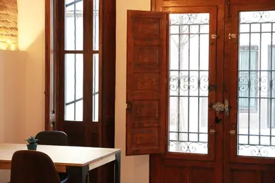 a room with a table and a door with windows at Grandma's fishermen's house in Cabanyal in Valencia