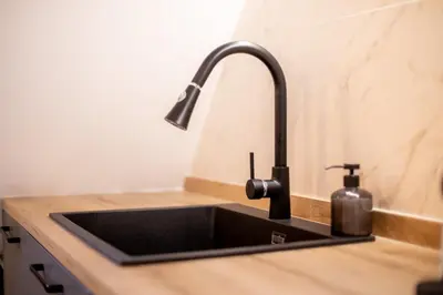 a kitchen sink with a faucet on a counter at Grandma's fishermen's house in Cabanyal in Valencia