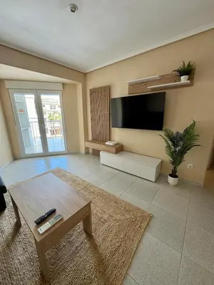 a living room with a large flat screen tv at 1st Line Beach Direct Access Private Parking in Valencia