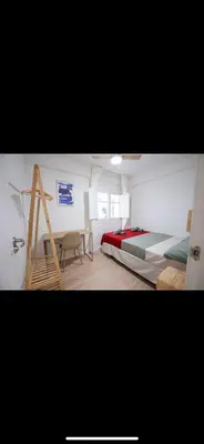 a bedroom with a bed and a ladder and a desk at Habitación luminosa en piso compartido in Valencia