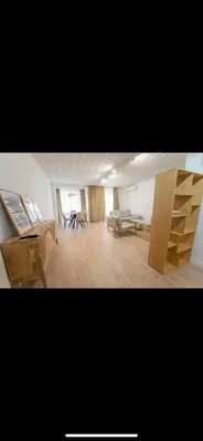 a living room with wooden furniture and a table at Habitación luminosa en piso compartido in Valencia