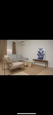 a living room with two chairs and a glass table at Habitación luminosa en piso compartido in Valencia