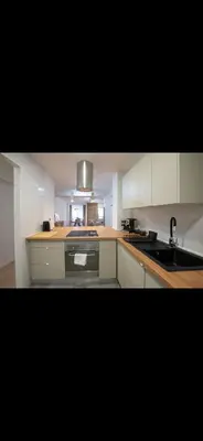 a kitchen with a sink and a stove top oven at Habitación luminosa en piso compartido in Valencia
