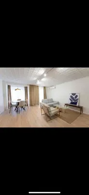 a living room with a couch and a table and chairs at Habitación El Cabanyal in Valencia