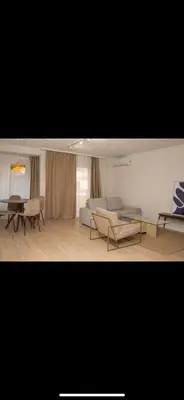 a living room with a couch and chairs and a table at Habitación El Cabanyal in Valencia