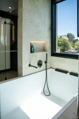a bathroom with a shower with a sink and a window at Villa Praya in Valencia in Bétera