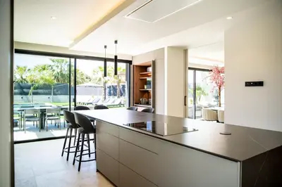 a kitchen with a large island and a dining room at Villa Praya in Valencia in Bétera