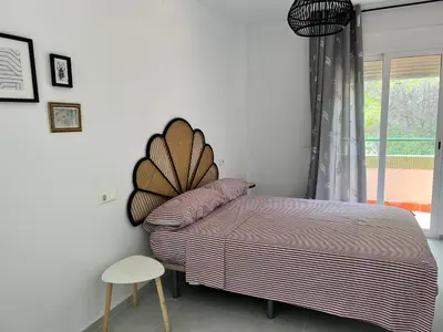 a bedroom with a bed and a chair and a window at Luxury villa with swimming pool in the forest in Gilet