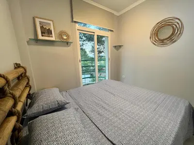 a bedroom with a bed and a window at Luxury villa with swimming pool in the forest in Gilet