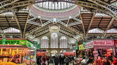 a market with people walking around in a building at Romantic Apartment Botanico by Virkin Suites in Valencia