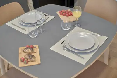 a table with plates and wine glasses and fruit on it at Romantic Apartment Botanico by Virkin Suites in Valencia