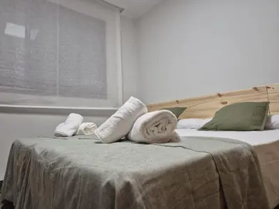 a bedroom with two beds with towels on the bed at PINEDO PLAYa in Valencia