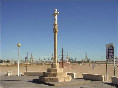 a statue on a pole in the middle of a beach at PINEDO PLAYa in Valencia
