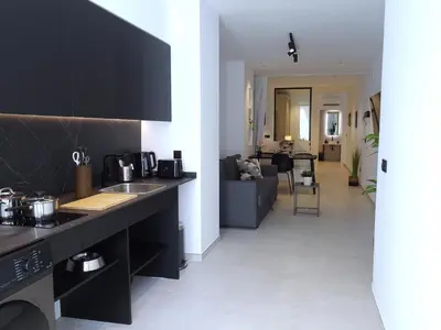 a kitchen with a counter top and a living room at BC22 - LoftValencia in Valencia