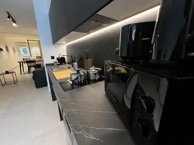 a kitchen with a black counter top with a microwave at BC22 - LoftValencia in Valencia