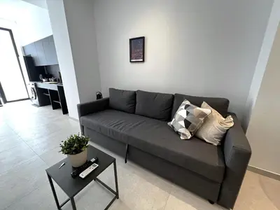 a living room with a gray couch and a table at BC22 - LoftValencia in Valencia