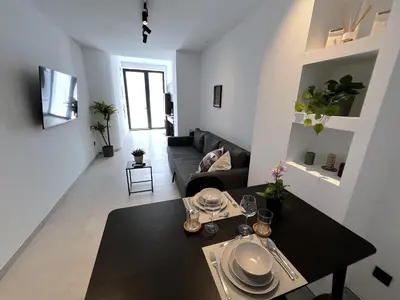 a living room with a couch and a table at BC22 - LoftValencia in Valencia