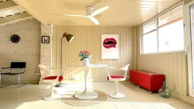 a room with two chairs and a table and a ceiling fan at Apartamento Joaquín Sorolla - Patraix in Valencia