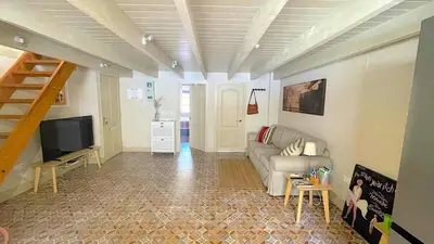 a living room with a couch and a television at Apartamento Joaquín Sorolla - Patraix in Valencia