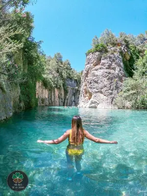 a woman standing in the water in a river at Maison bord de plage avec patio extérieur aménagé in Puerto de Sagunto