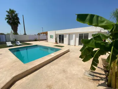a swimming pool in the backyard of a house at Villatella in Burriana
