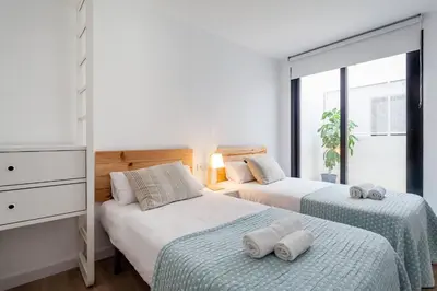 a bedroom with two beds with towels on them at AIRE Holidays Valencia in Valencia