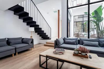 a living room with two couches and a table at AIRE Holidays Valencia in Valencia